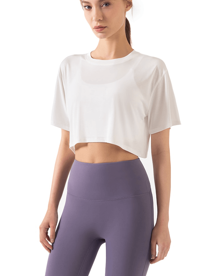 Woman wearing Ultralight Elastic Breathable Short Sleeves Gym Fitness T-Shirt in white, paired with purple leggings, showcasing comfort and style.
